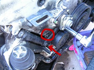 hidden bolts of the timing belt cover under the shock