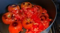 place fried stuffed tomatoes in pan